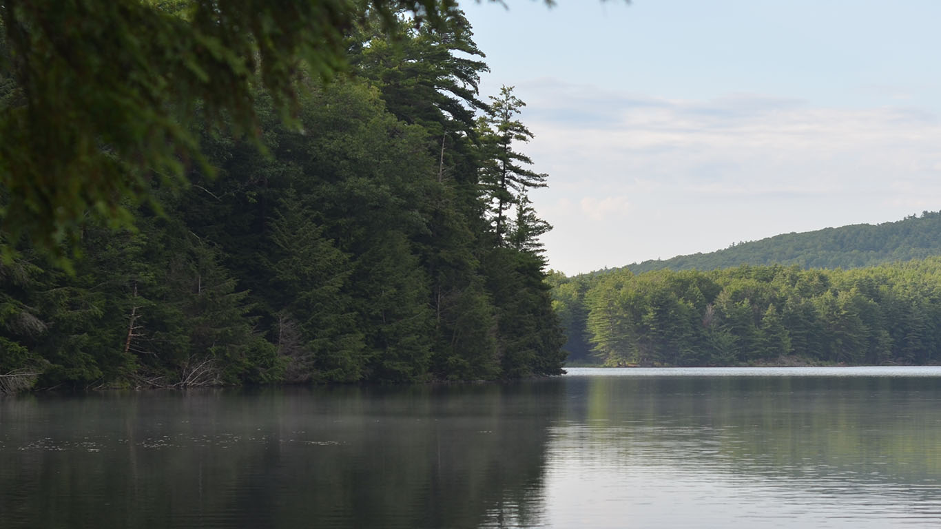 A lake in Vermont with tress on the shore.